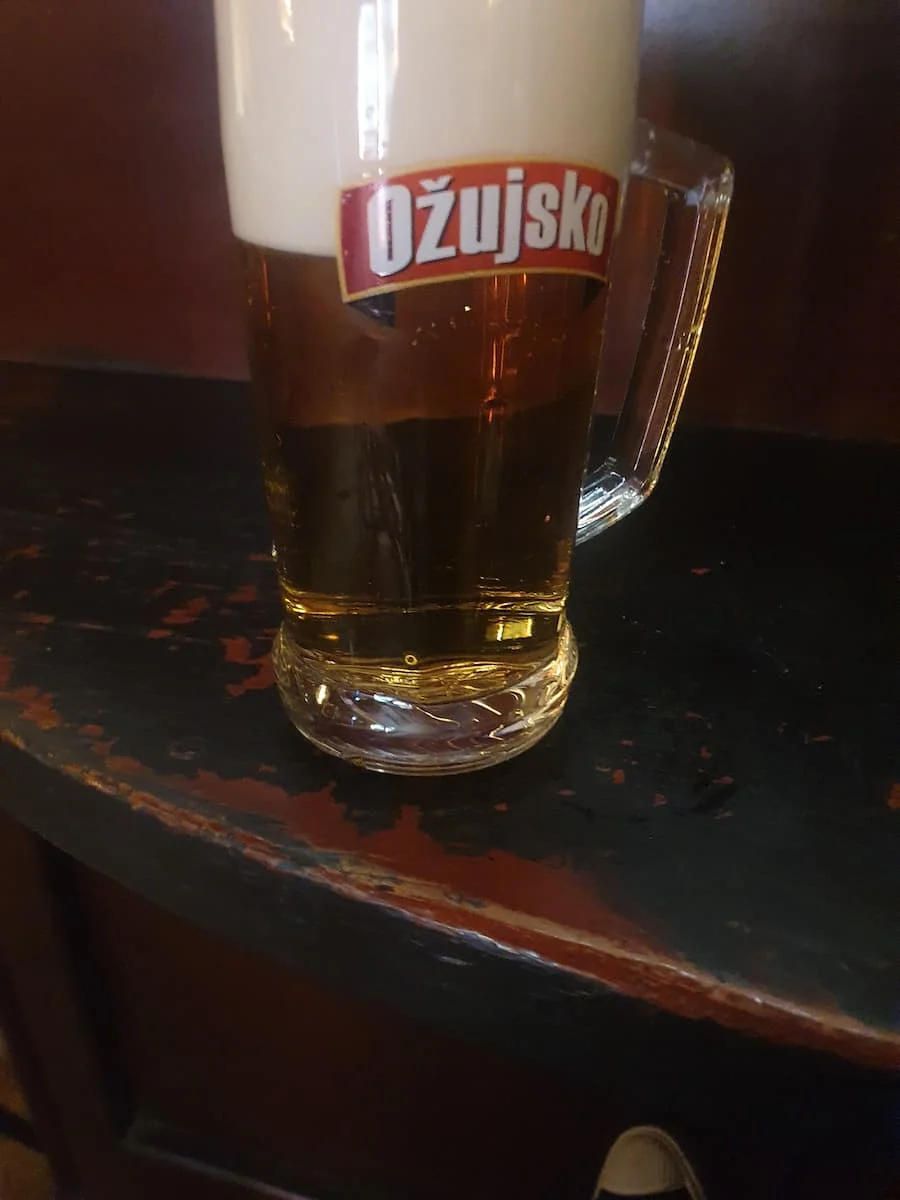 a pint glass containing croatian ozujusko lager beer at city pub in sarajevo bosnia