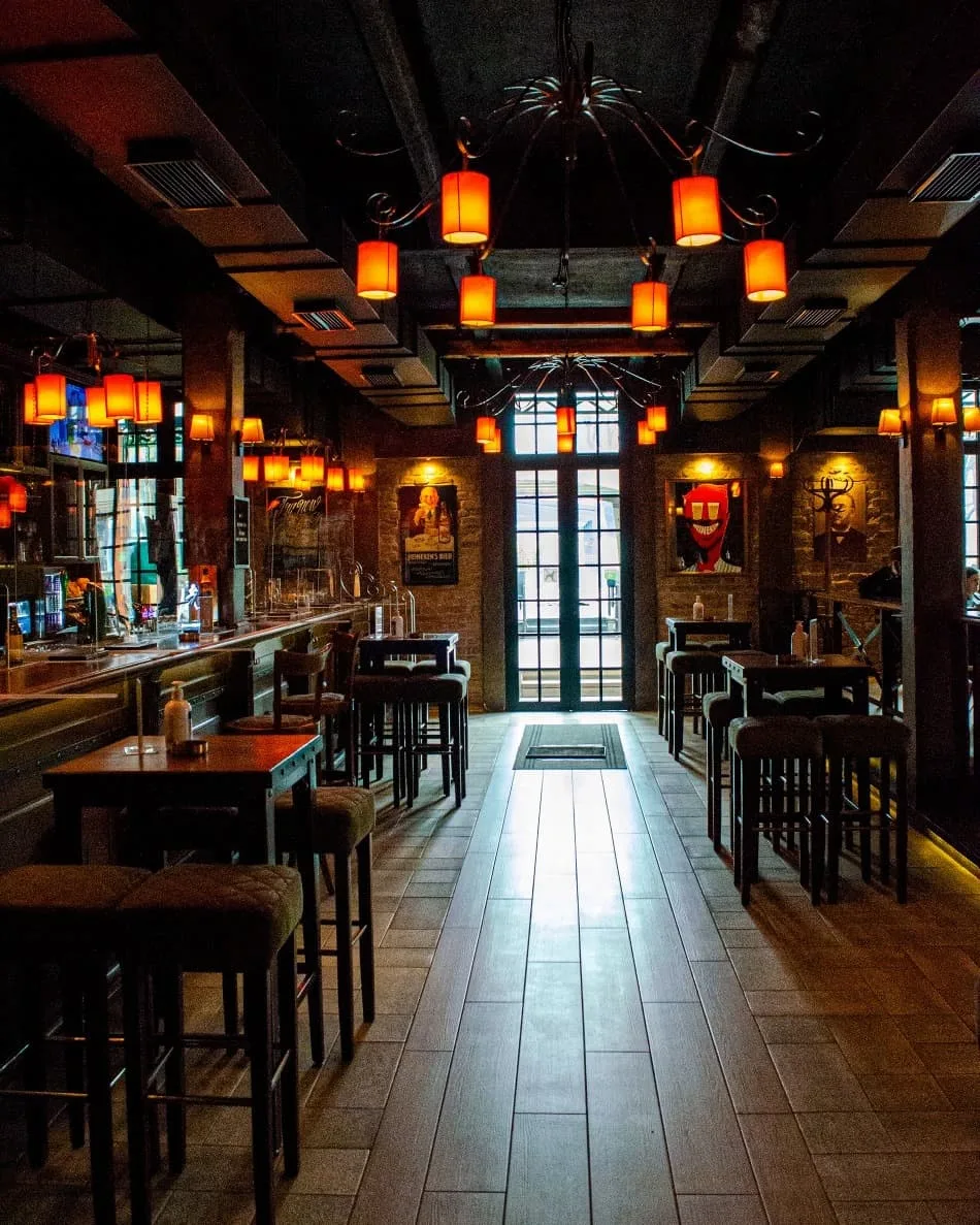 the dimly lit wood panelled bar of aquairus vils in sarajevo bosnia