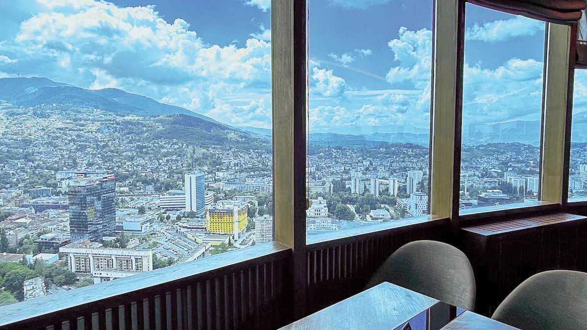 view of sarajevo with the hotel holiday in the foreground and mountains in the background seen from sky lounge 35 bar in the avaz twist tower sarajevo bosnia
