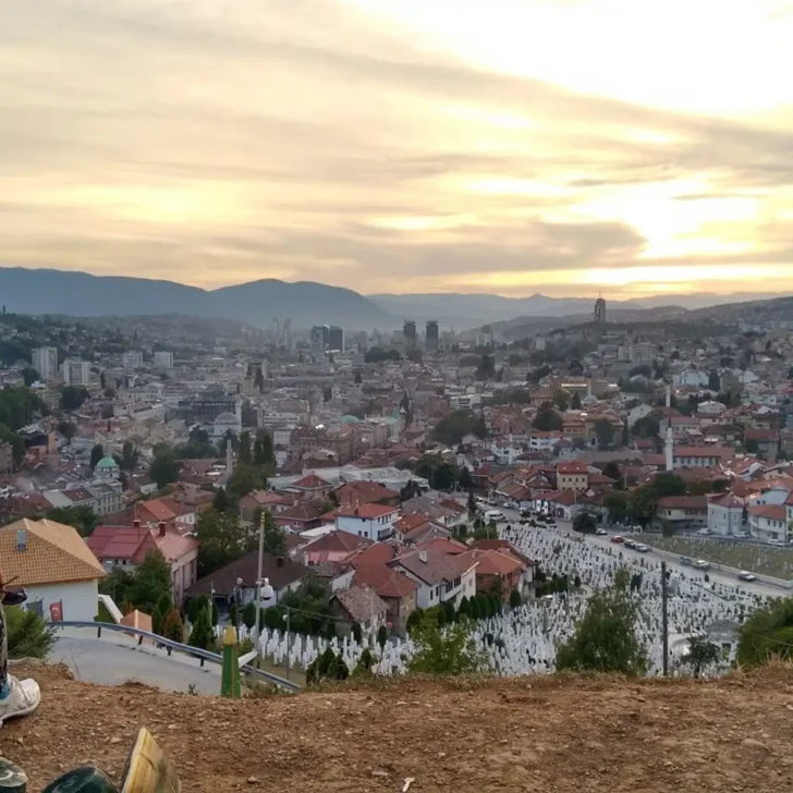 a woman watches sunset over sarajevo bosnia and herzegovina from the yellow fortress