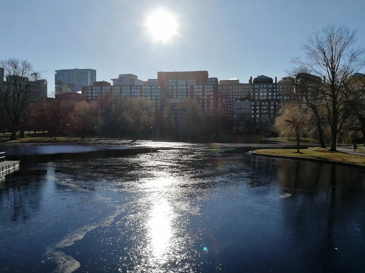 sun reflecting off a frozen pond in boston common Massachusetts usa