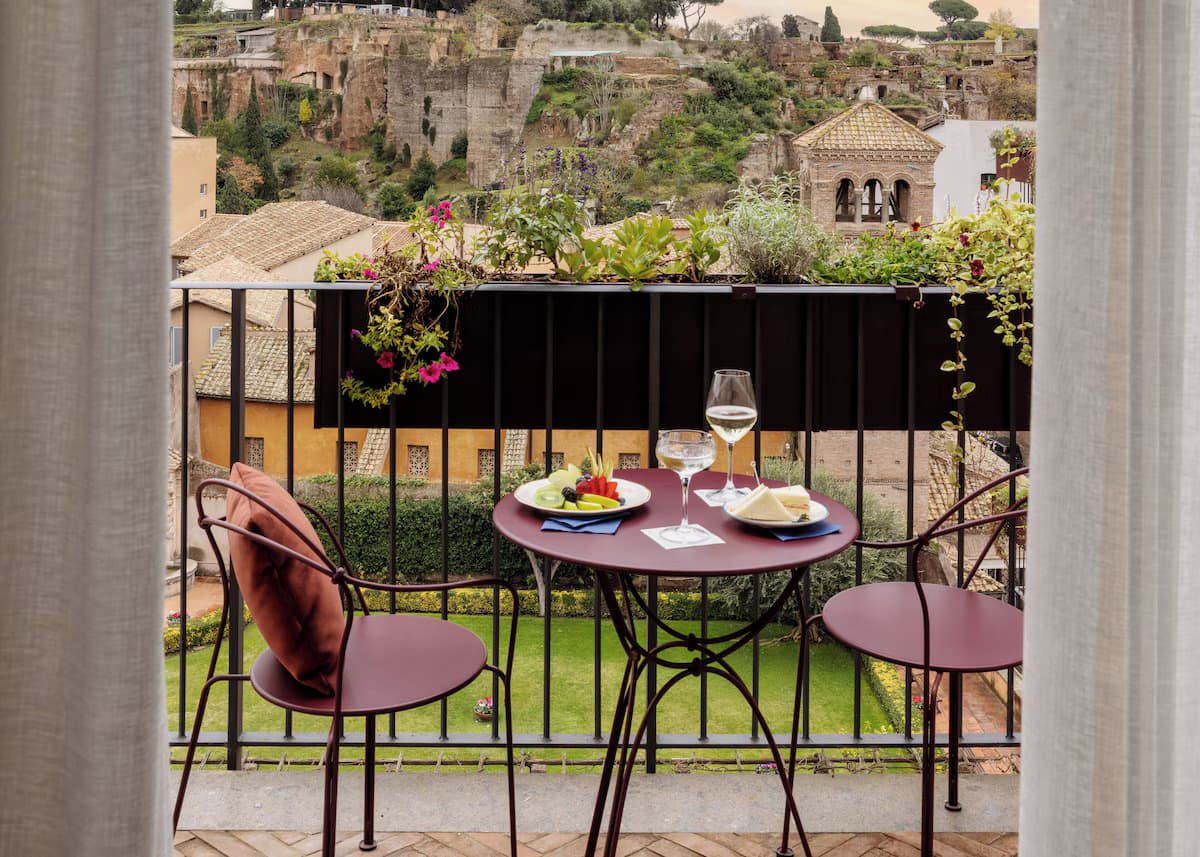 Afternoon apertivo at the Aventino stay overlooking ancient buildings yonder
