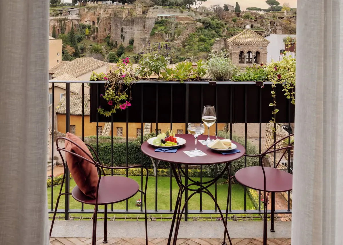 Afternoon apertivo at the Aventino stay overlooking ancient buildings yonder