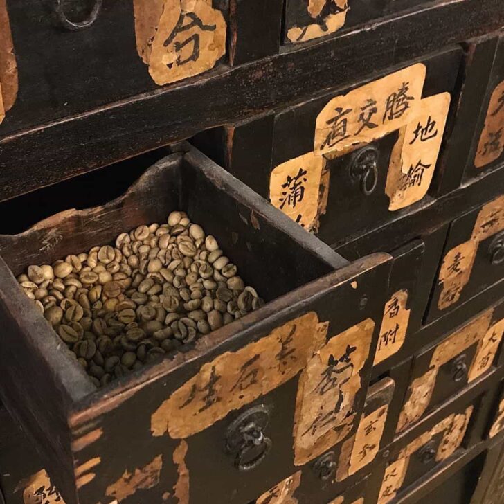 Antique drawers are filled with coffee beans at this coffee shop