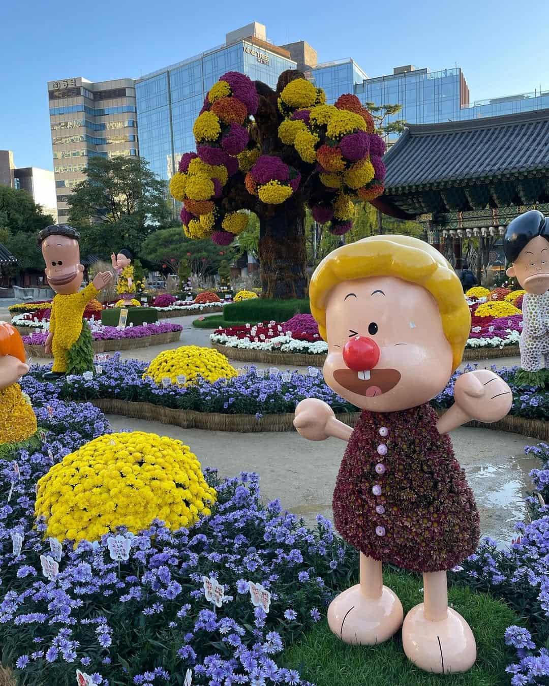 Decorative flower displays and statues at this Korean Buddhist temple