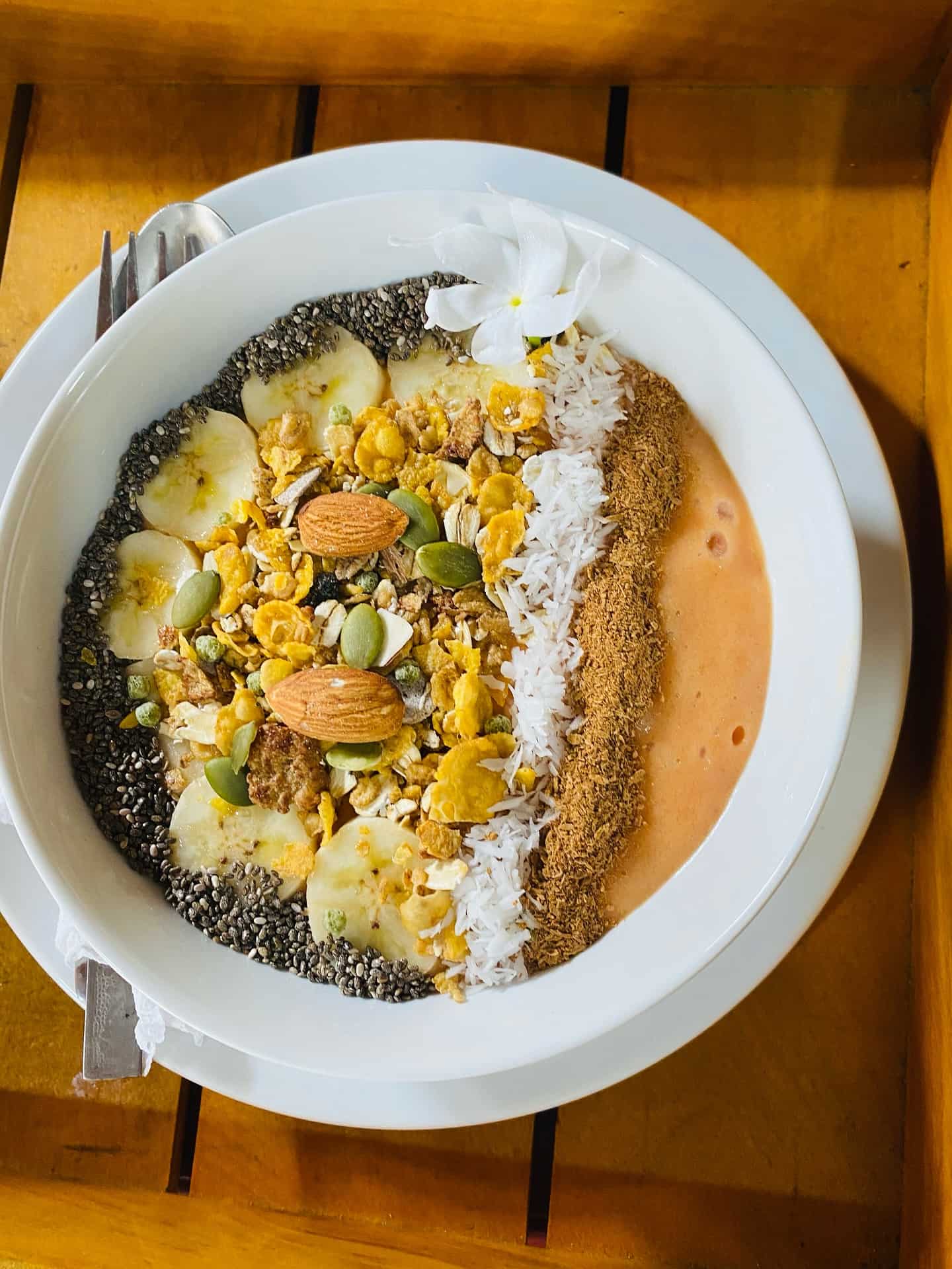 Smoothie bowl with chia seeds, cacoa nibs, nuts and fruit