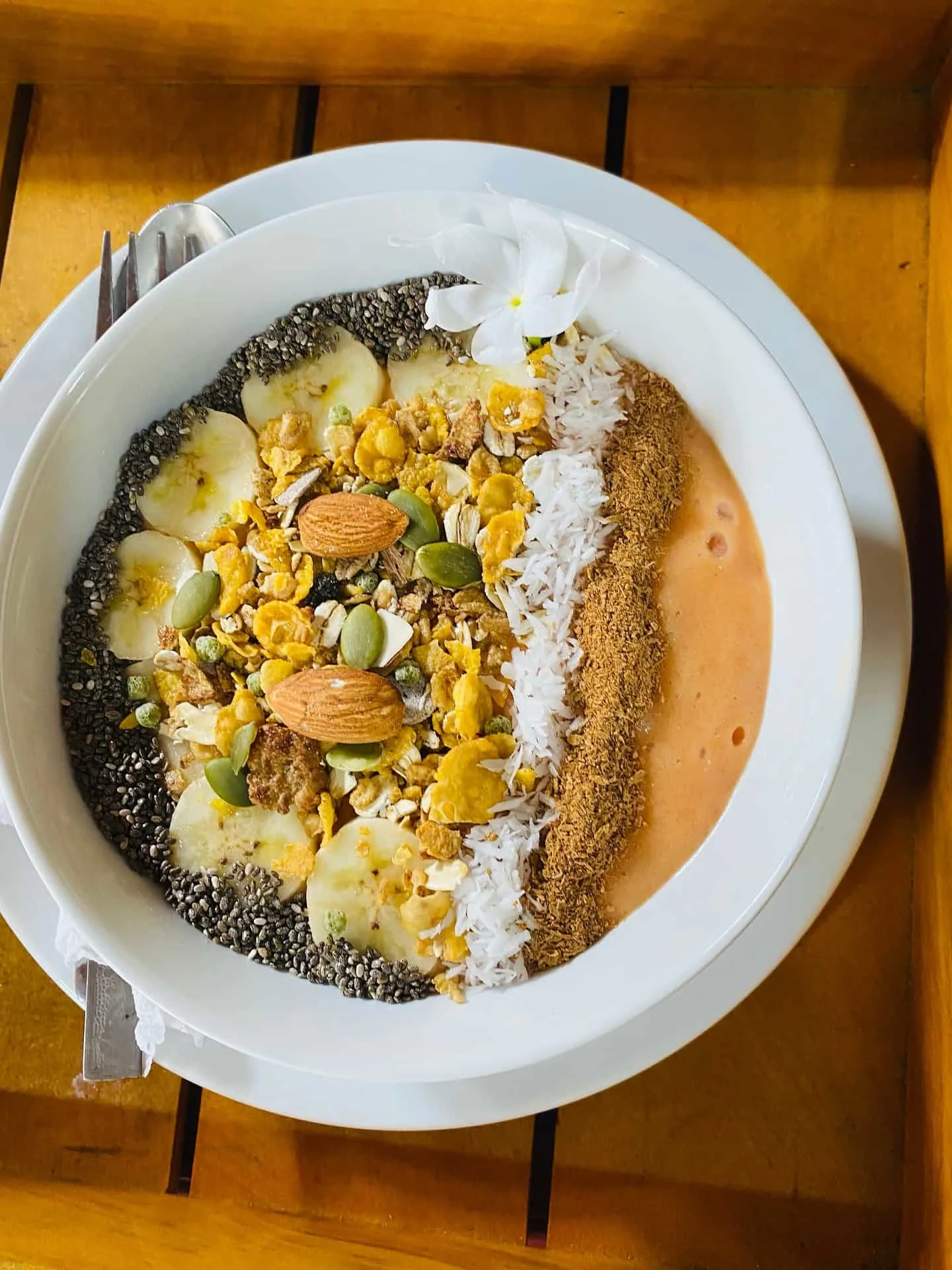 Smoothie bowl with chia seeds, cacoa nibs, nuts and fruit