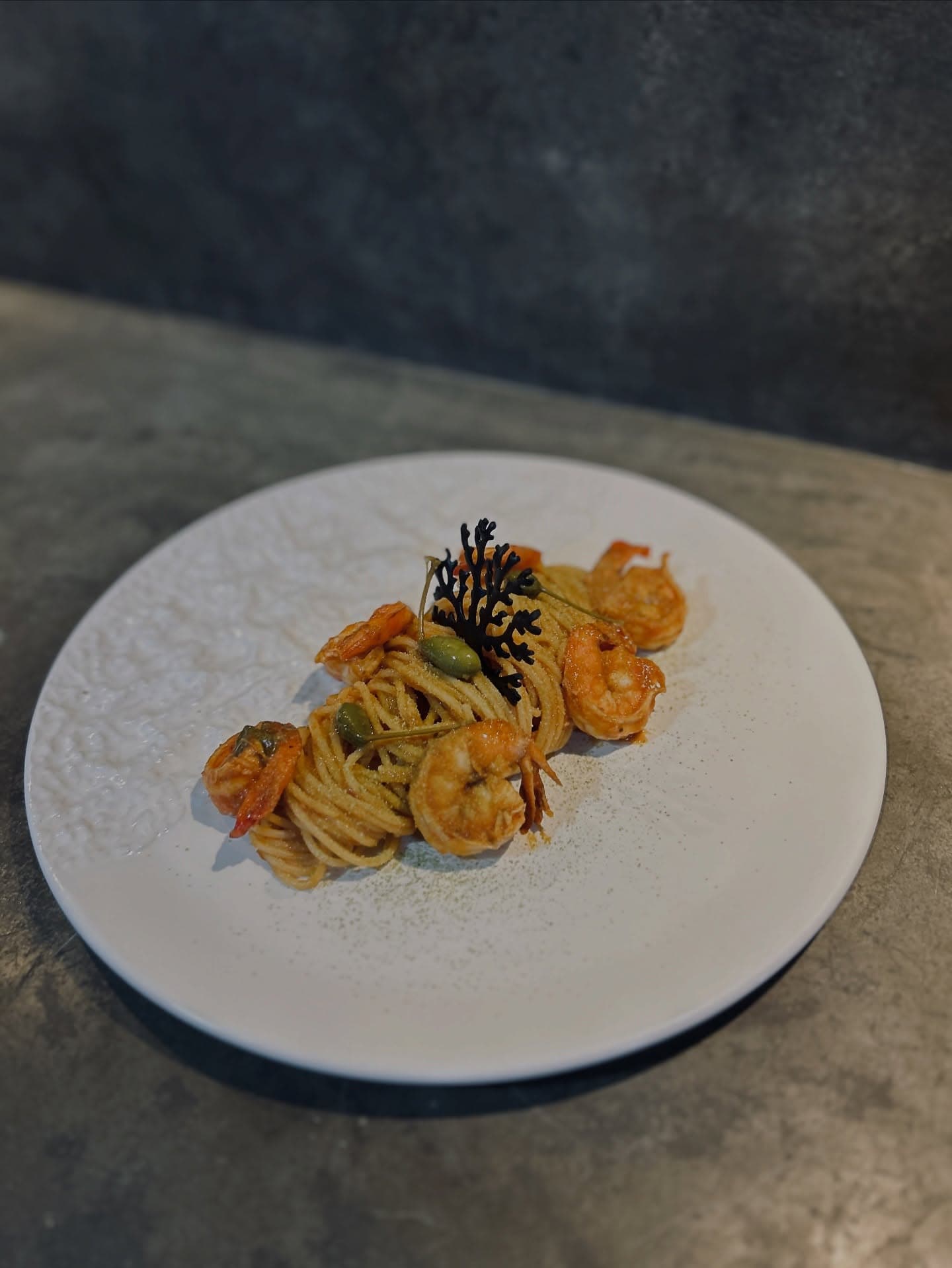 Handmade pasta with prawns and capers