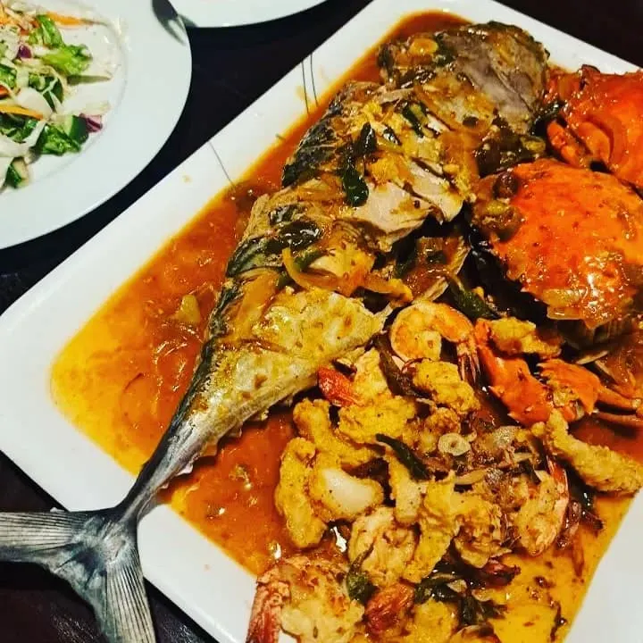 Seafood platter with whole fish, crab, prawns
