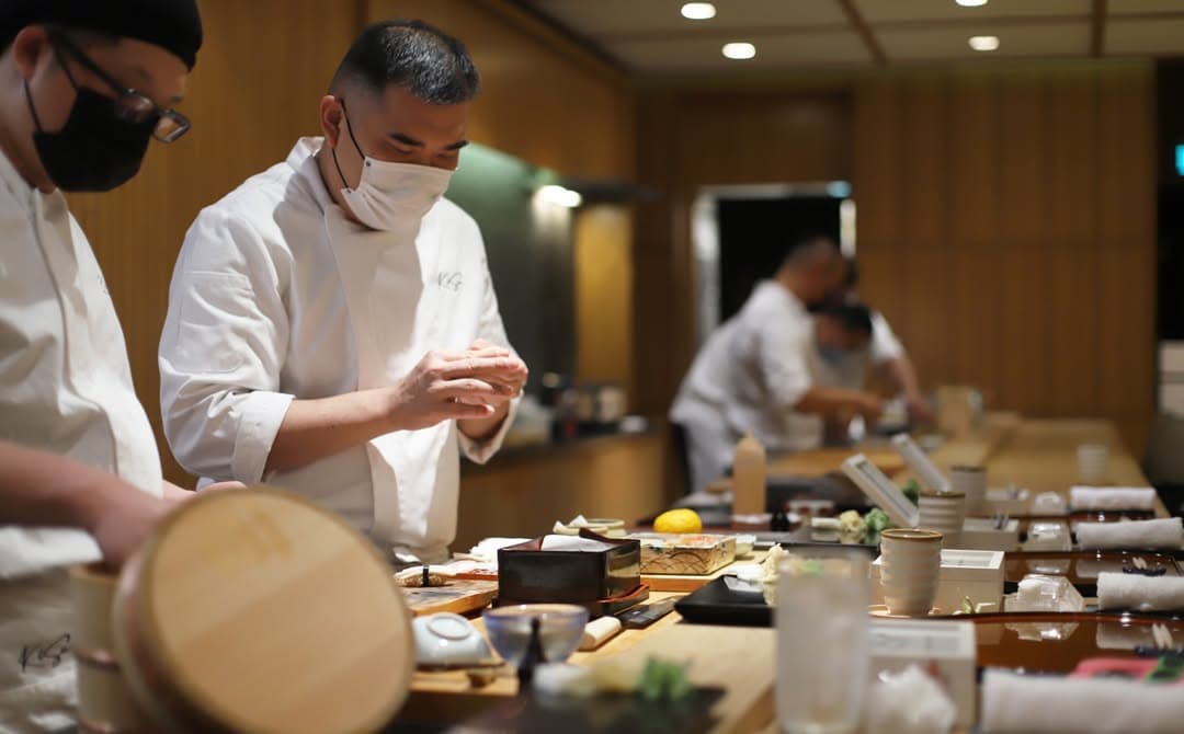 Fine dining style Japanese omakase setup with chefs ina ction