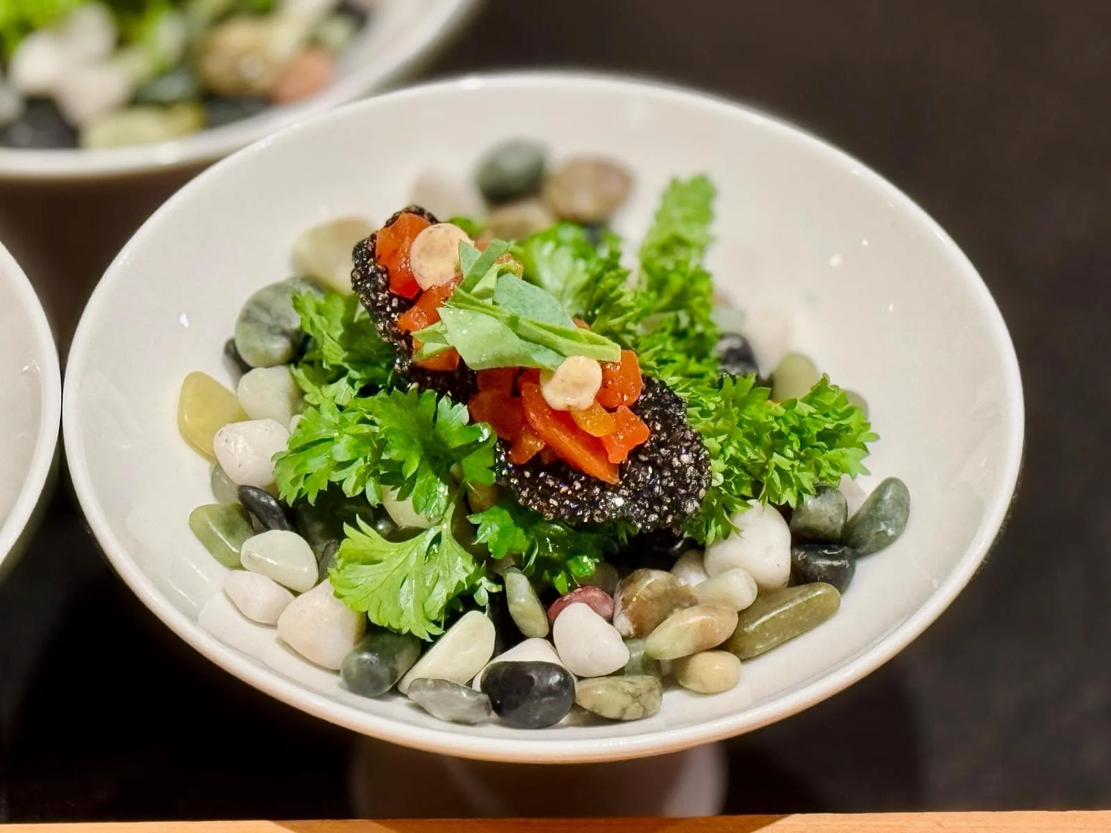 Food is beautifully presented on a bed of gemstones