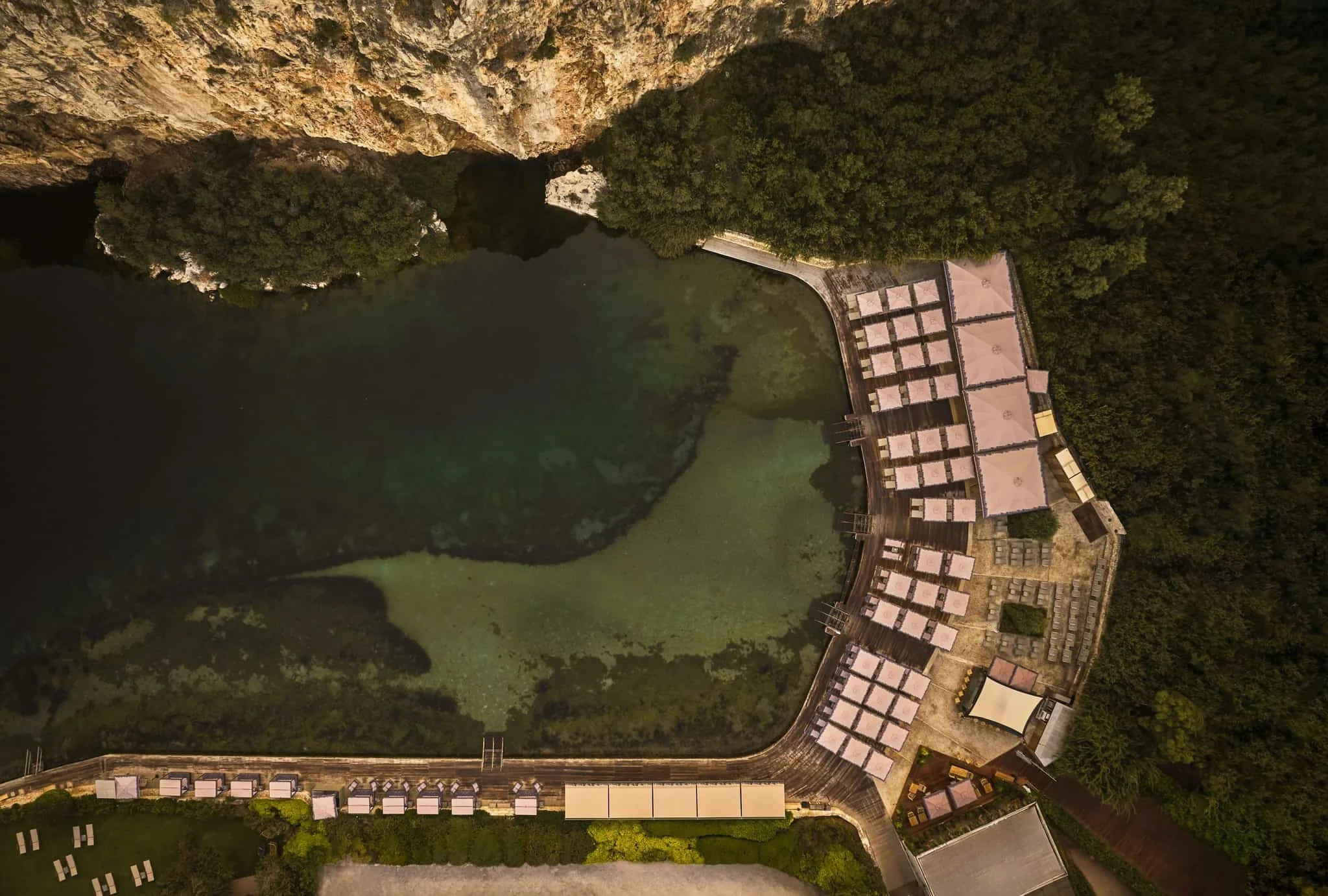 Bird's eye shot of the healoing thermal lake including the seats and on-site restaurant and spa