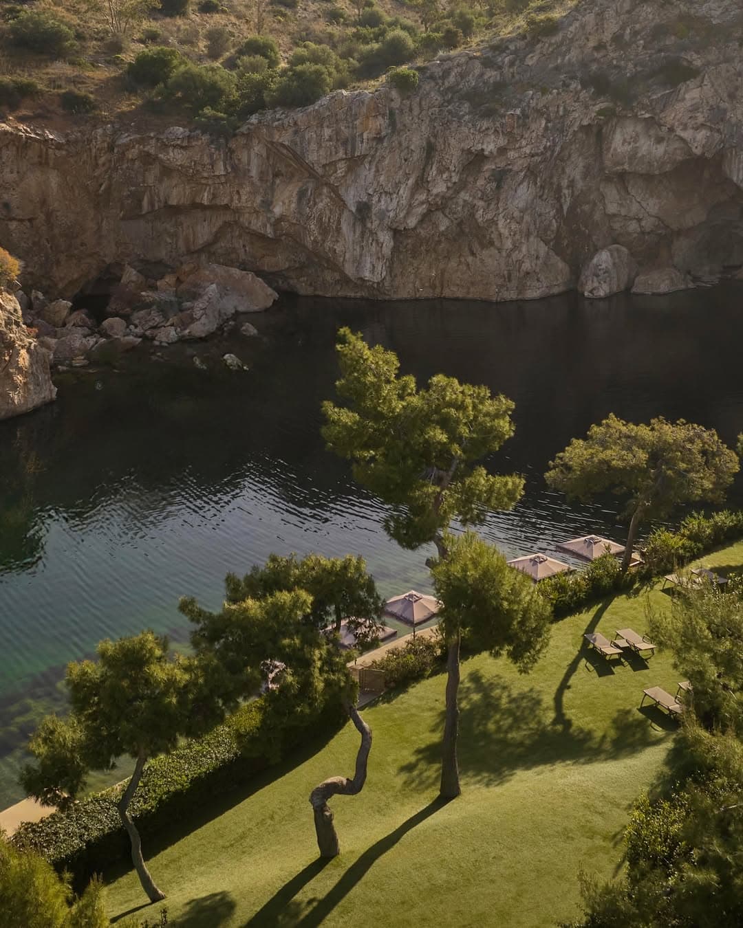 An overview of the lake nestled between a cliff