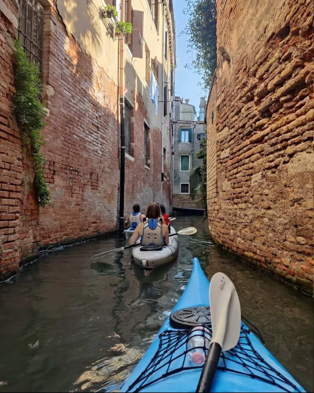 Cruising through the narrow canals on kayak is one of the most unusual things to do in Venice