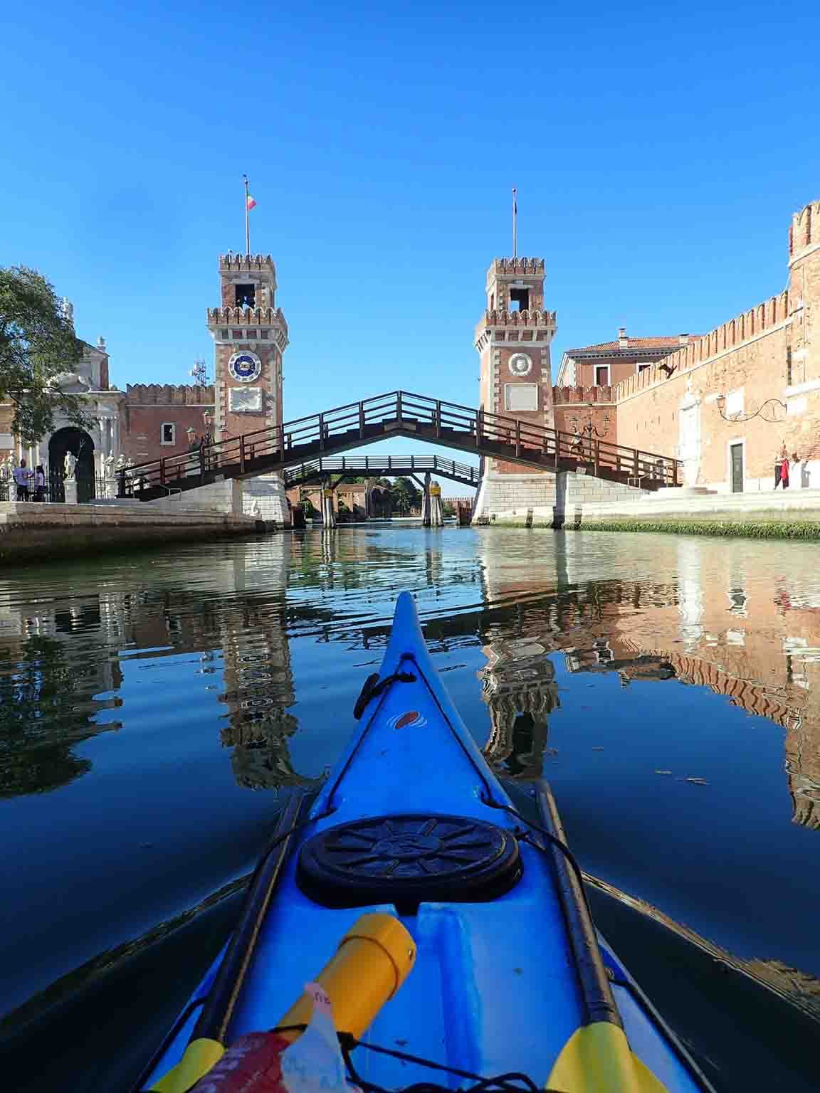 Going under a bridge during venice canal kayak expedition