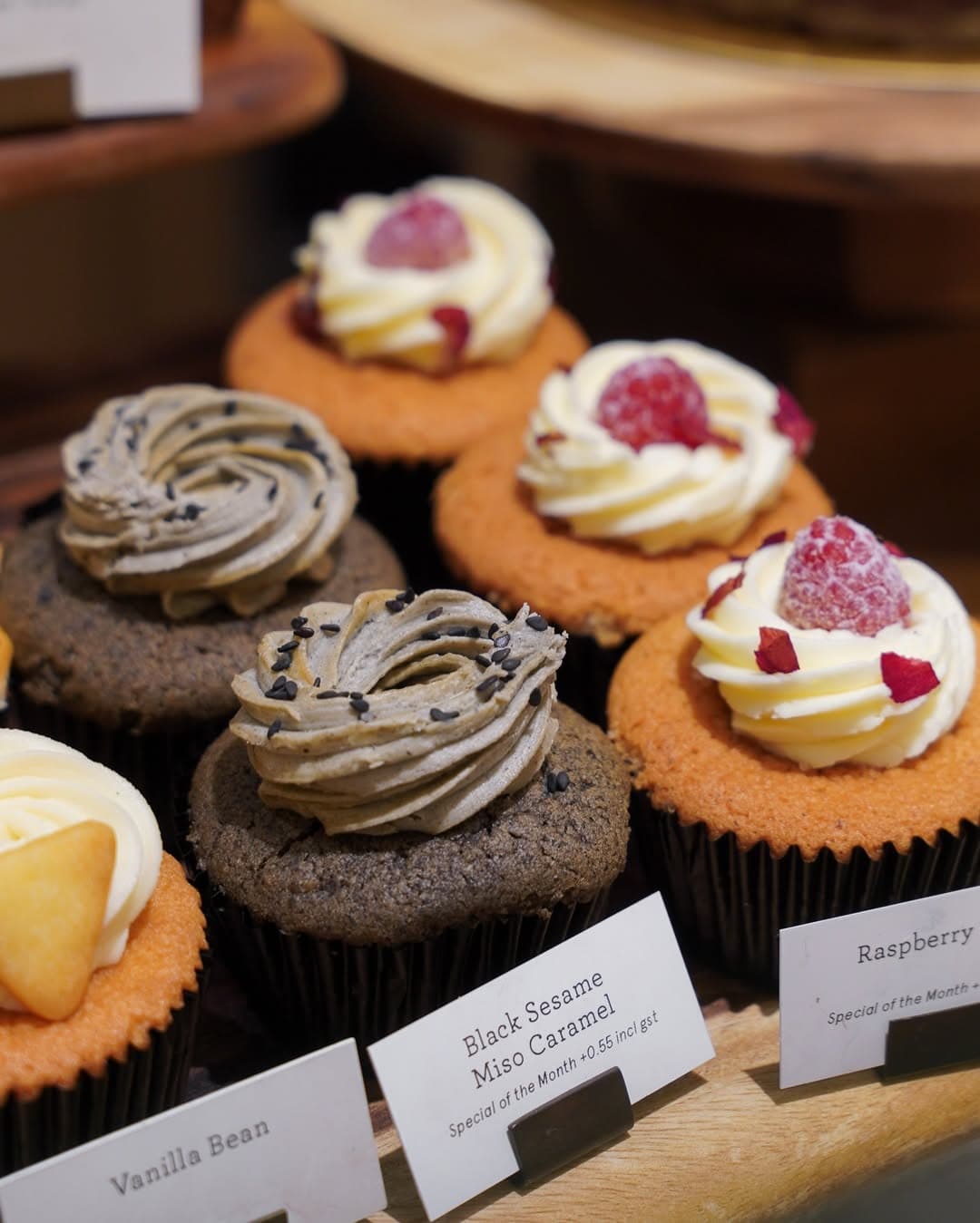 Cupcakes on display inclusding black sesame miso caramel