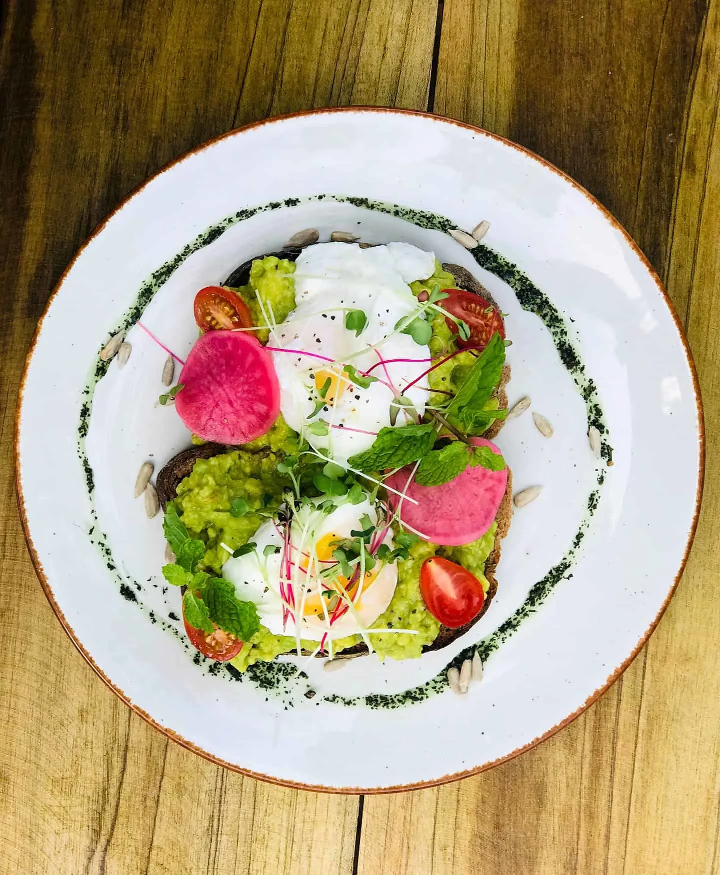 Smashed avocado toast with fried eggs