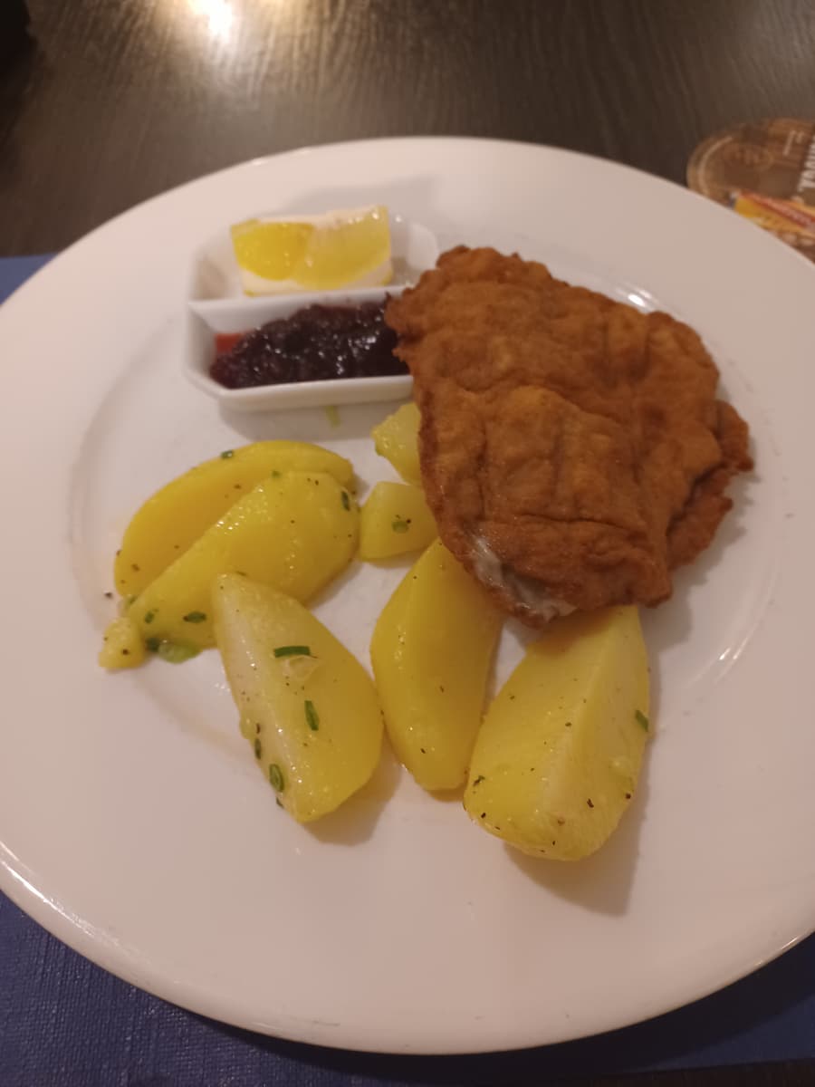 schnitzel weiner art and buttered potatoes served on a white plate at restaurant engel in vaduz liechtenstein