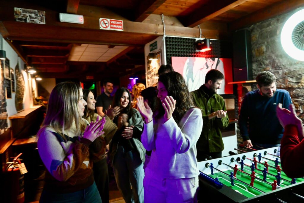 people chatting around a table football table in footlights bar trieste italy