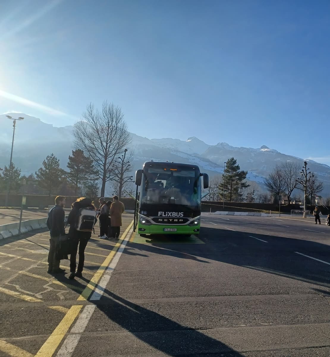 a flixbus in vaduz bus station lichtenstein with alpine mountains in the background