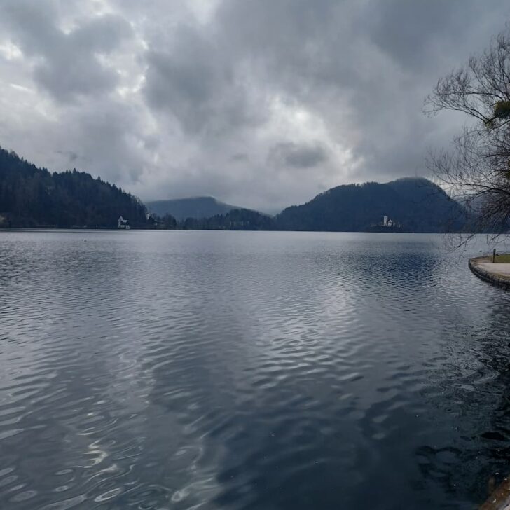view of lake bled slovenia from bled town with alpine mountains in the distance