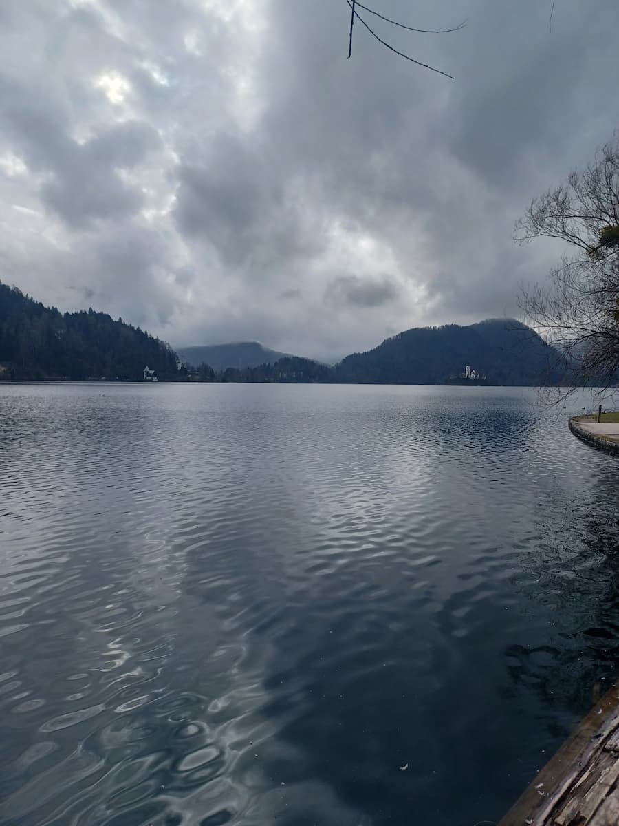 view of lake bled slovenia from bled town with alpine mountains in the distance