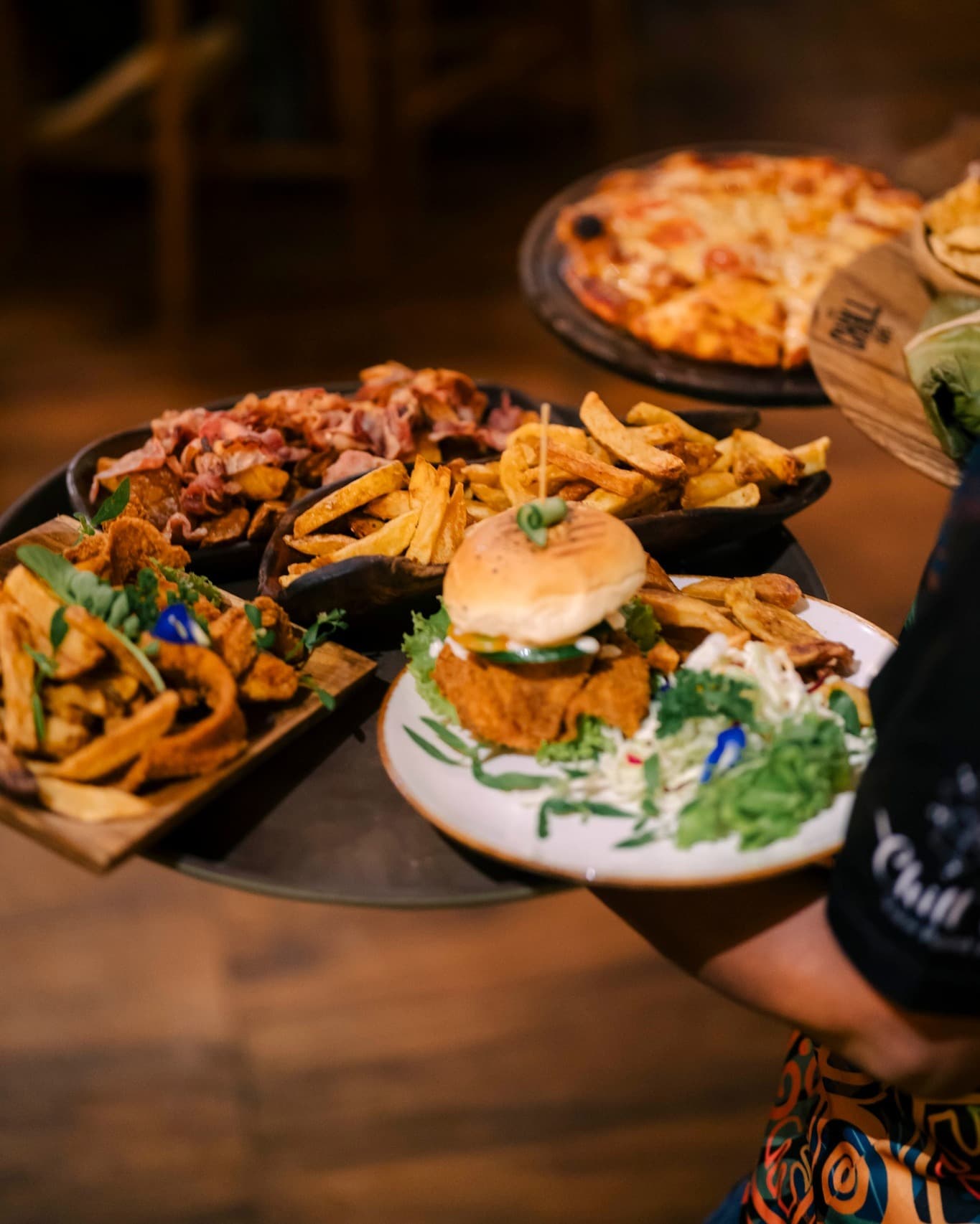 Burger, pizza and nachos with bacon
