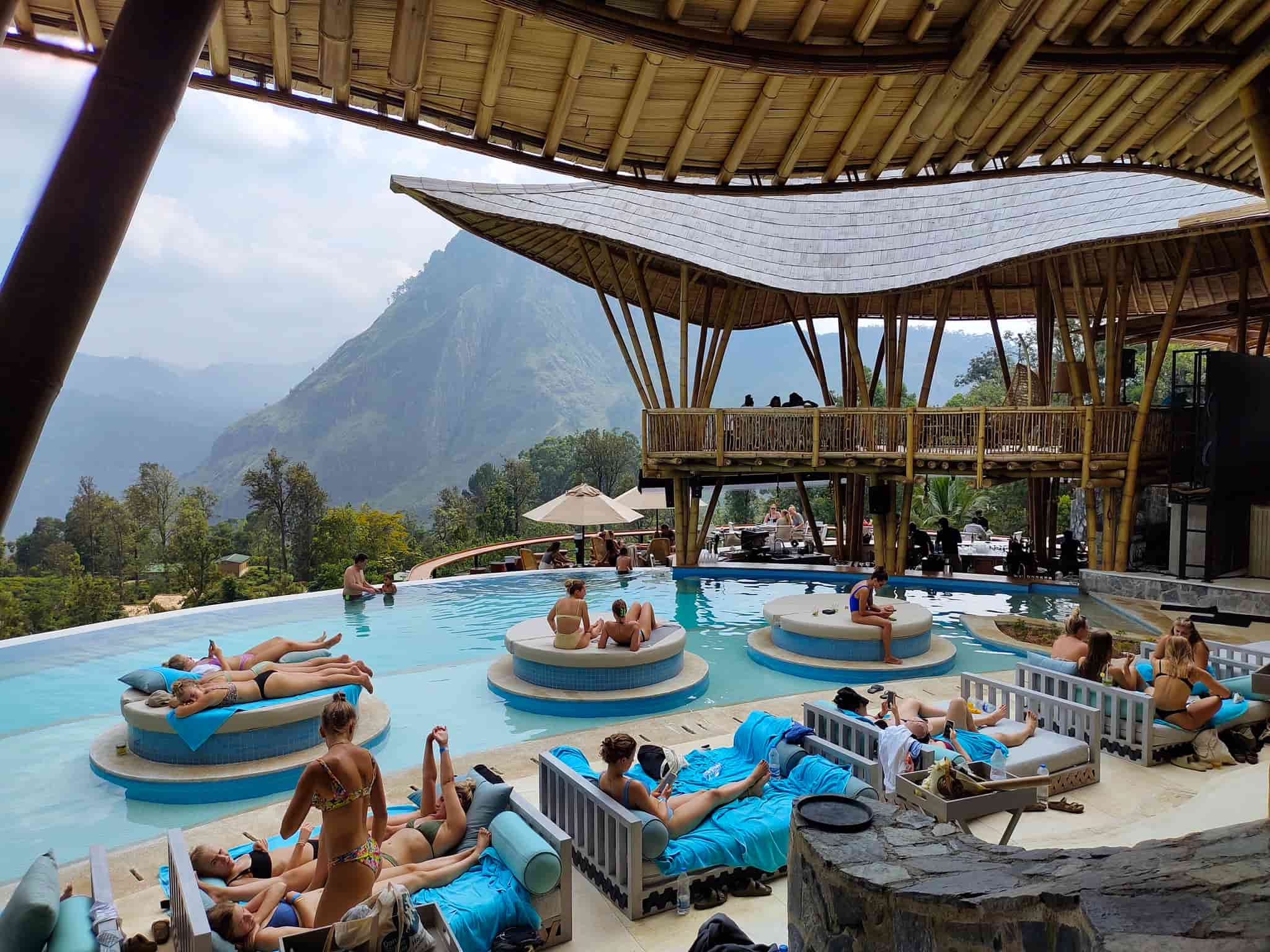 A full house of guests chilling around the pool and on day beds