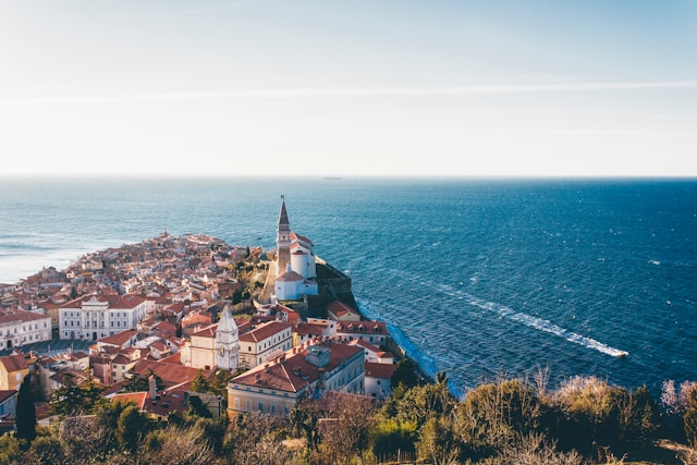 the walled old town of piran slovenia on the adriatic sea with a lighthouse in the background