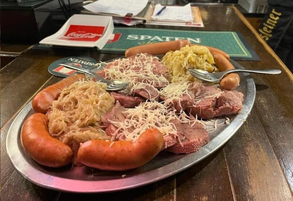 a silver platter lined with bolliti pork sausages a delicacy from trieste italy at birreria da rudy