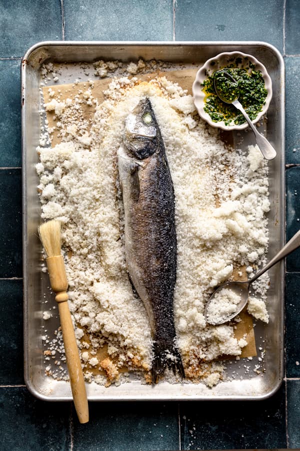 a baked whole sea bass branzino on a baking tray in slovenia
