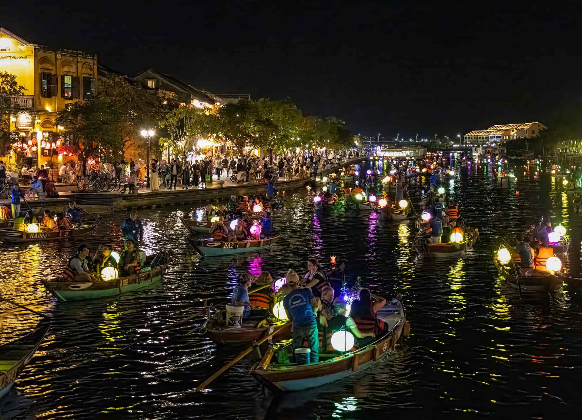 The river with the night market on the left hand side in full swing