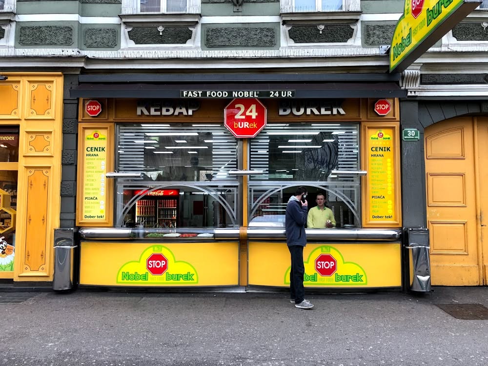 a yellow shop front of nobel burek a popular 24-hour fast food restaurant in ljubljana station