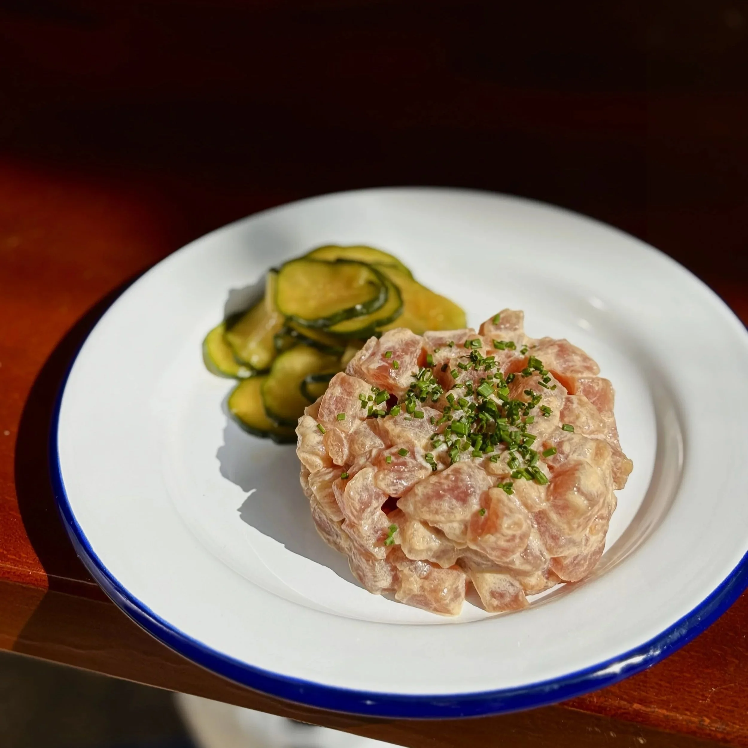 tuna tartare and cucumber on a white plate at voyager craft bar ljubljana slovenia