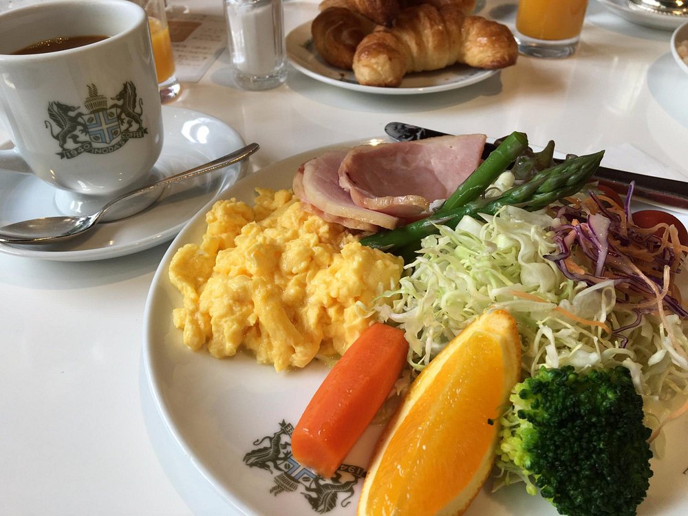 Breakfast plate containing eggs, ham, fruits, and vegetables at Inoda Coffee Kyoto