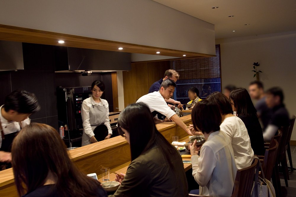Staff explaining breakfast dishes at Kishin, Kyoto
