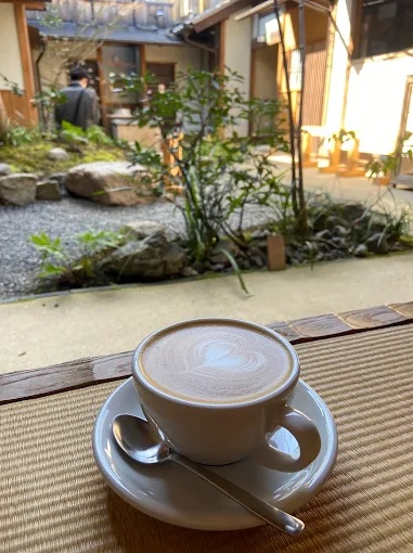 A cup of coffee on a counter overlooking a Japanese courtyard