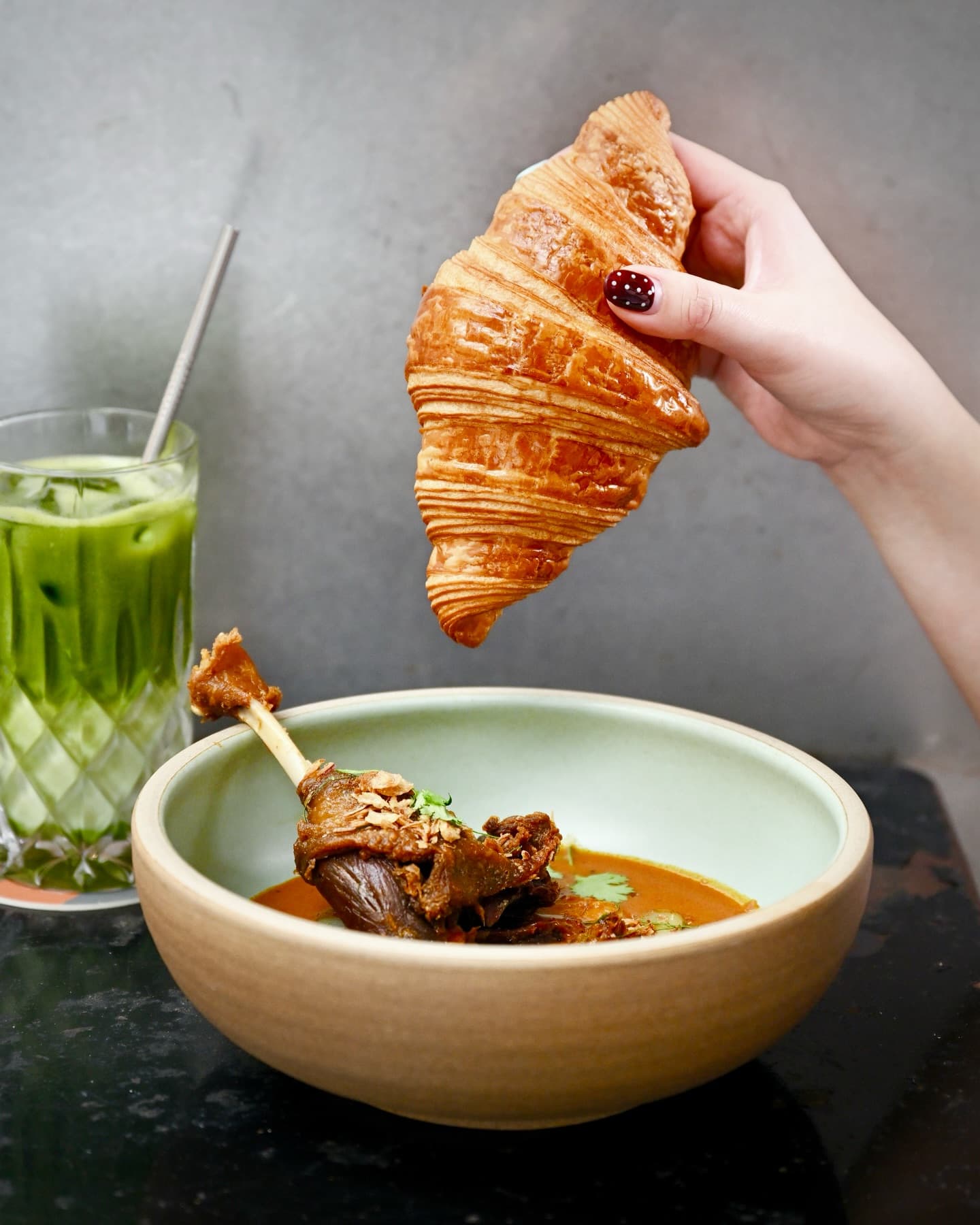 crispy duck curry served with croissant