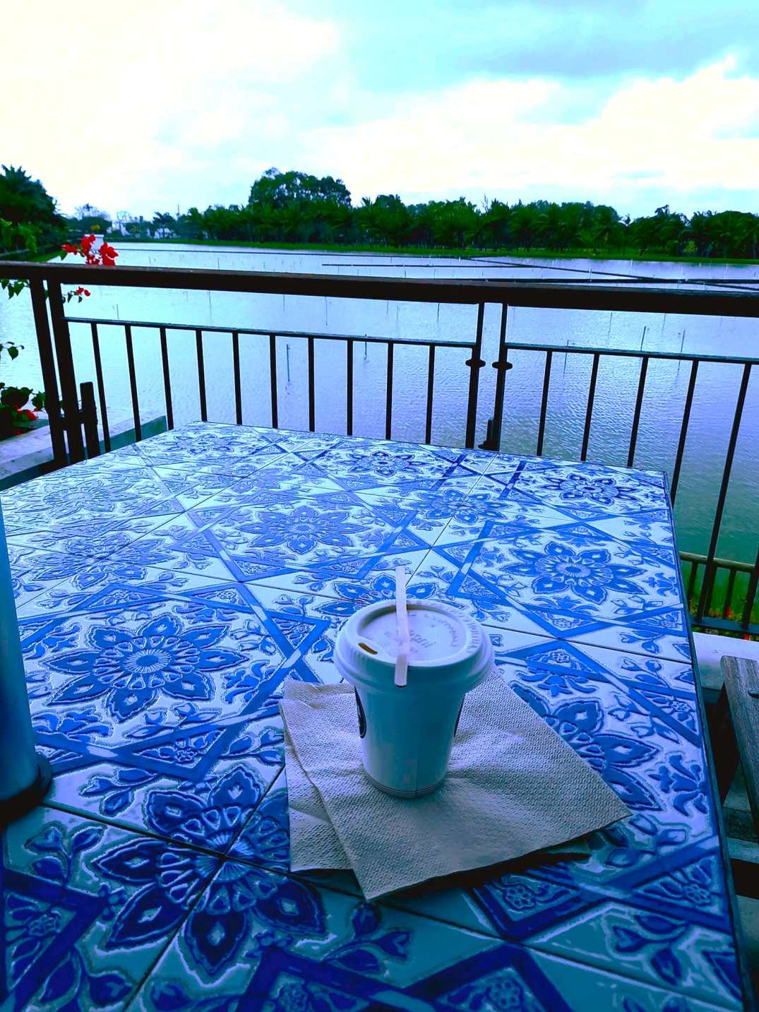 A cup of coffee in front of a lake