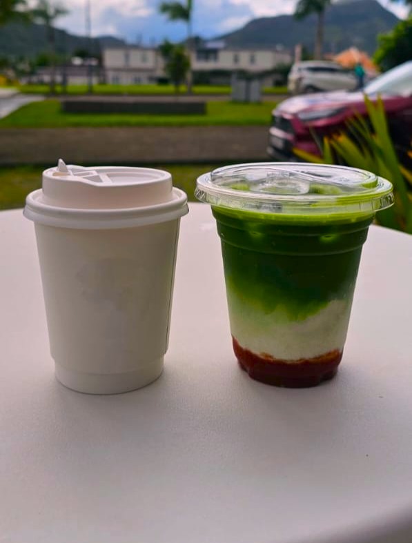 A pair of takeout coffee cups on a table
