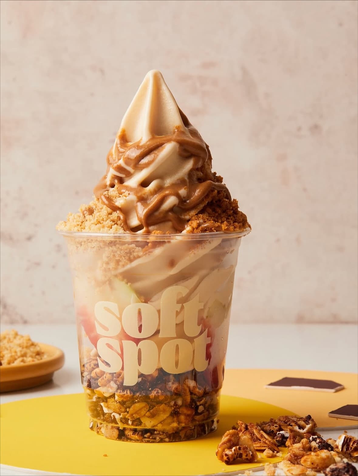 açaí parfait constructed from the berries, granola, almond flakes, peanut butter sauce, fruit, and digestive crumbs